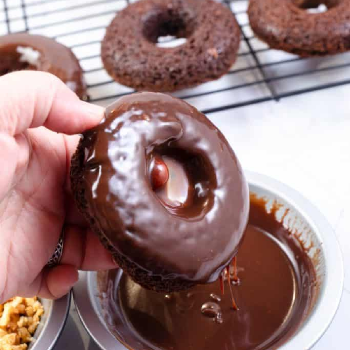 Homemade copycat Dunkin’ Donuts chocolate glazed donuts with shiny chocolate coating.