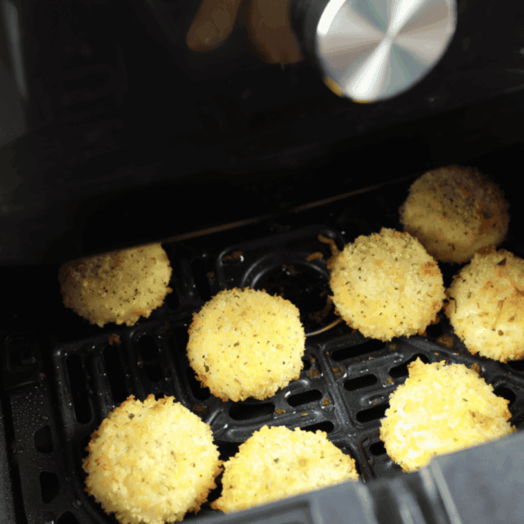 Babybel Cheese cooking in the air fryer basket.