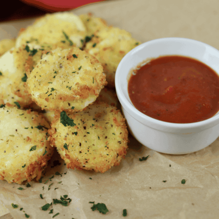 “Golden, melted Air Fryer Babybel Cheese bites on a plate, crispy outside and gooey inside.”