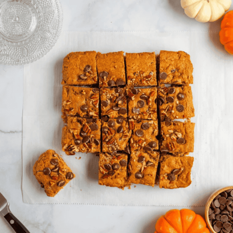 Air fryer blondies cut into golden brown squares with chewy centers and crisp edges on a cooling rack.