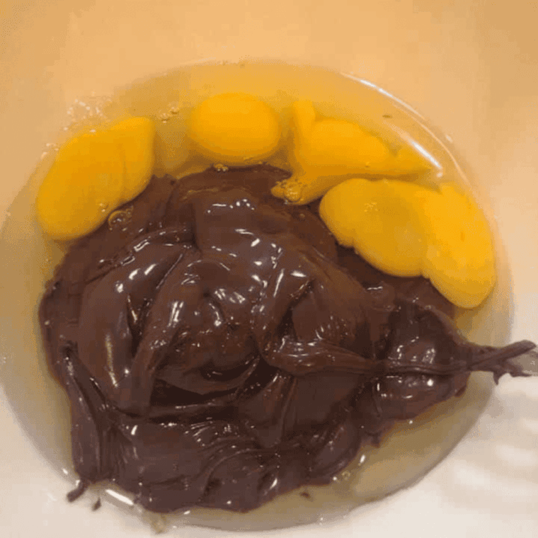 Mixing Nutella and eggs in a bowl until smooth.