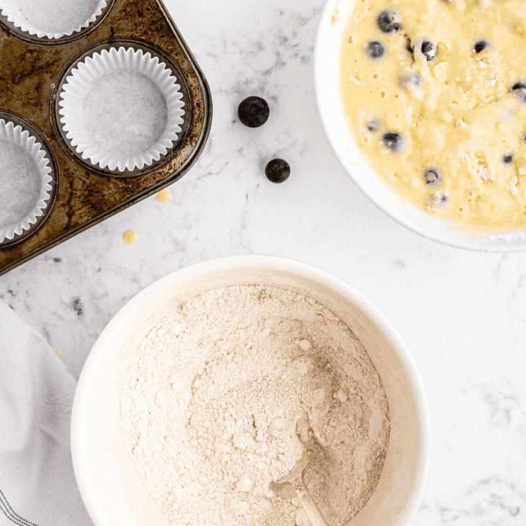 Ingredients needed for Air Fryer Copycat Panera Wild Blueberry Muffins on kitchen table.