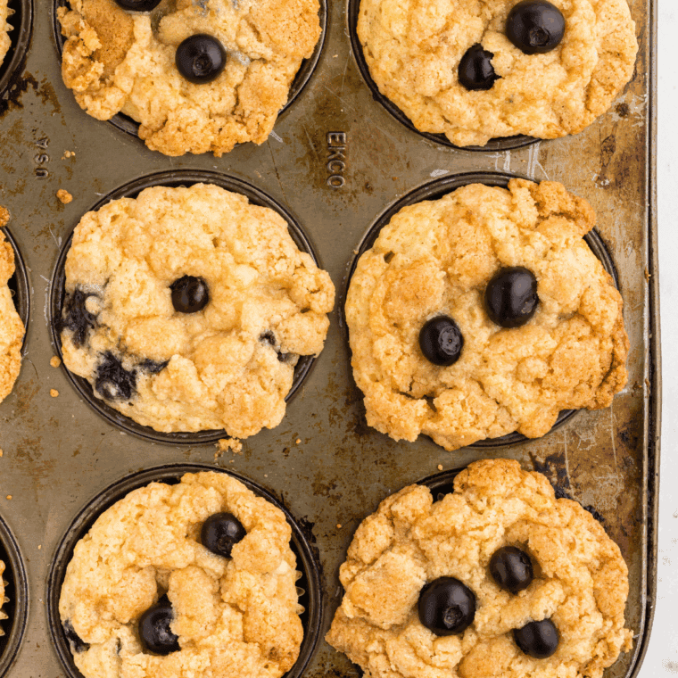 Golden air fryer wild blueberry muffins with a sweet crumb topping, fresh from the air fryer