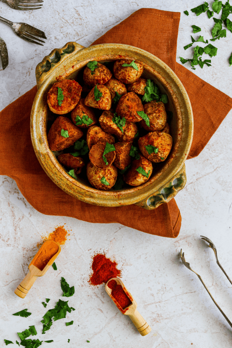 overhead shot

Overhead view of crispy curry potatoes in a shallow bowl on a linen napkin