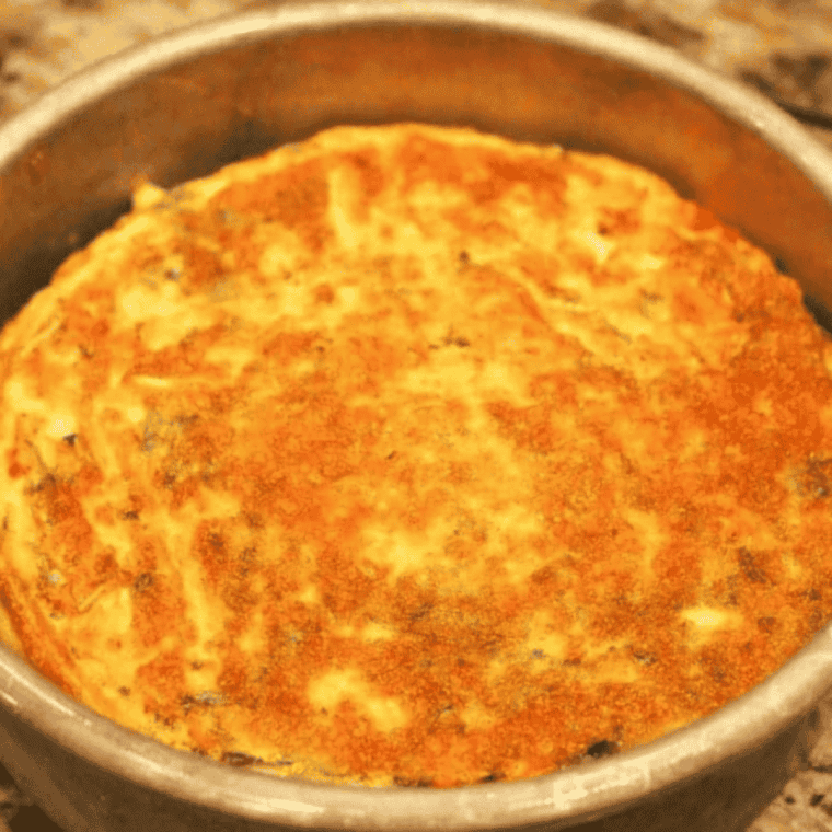 Toothpick test on golden air fryer frittata to check the center is set