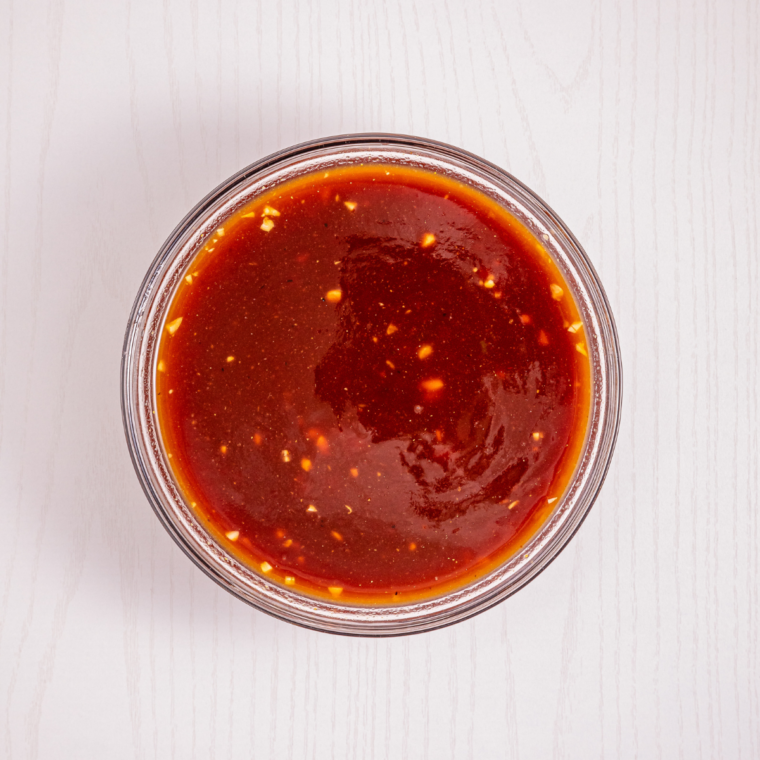 Garlic sautéing in butter in a small saucepan with ketchup, honey, and soy sauce added