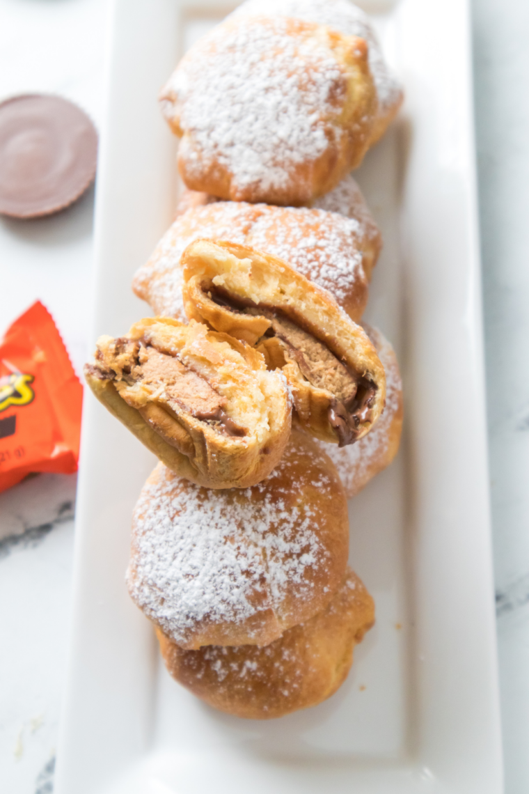 Air fryer Reese&rsquo;s peanut butter cup bombs baked in dough until golden outside with melted chocolate and creamy peanut butter center ready in 8 minutes