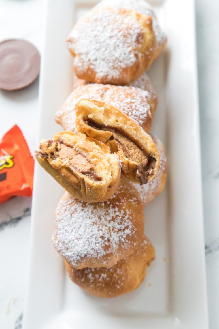 Air fryer peanut butter cup bombs wrapped in dough and cooked until golden brown with gooey melted Reese&rsquo;s center for a quick sweet snack