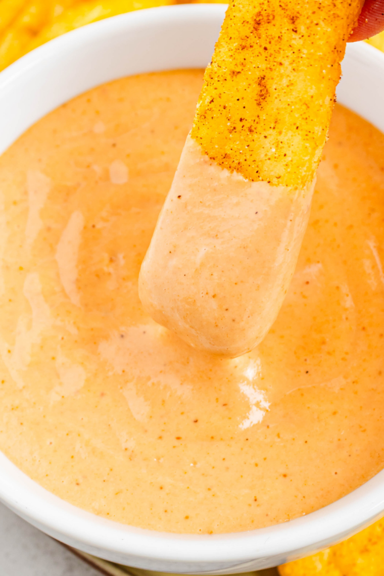 French fries on a plate next to a small bowl of copycat Cane’s sauce