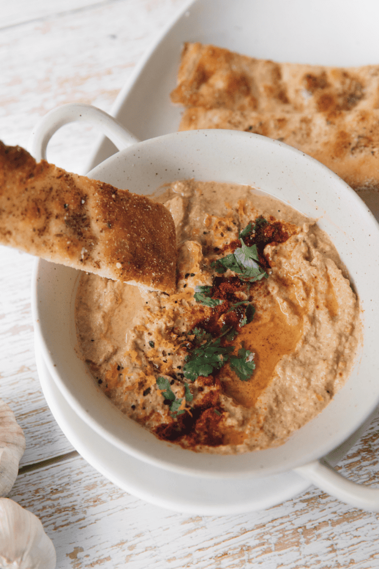 Crispy baked pita chips seasoned with olive oil and spices served as a crunchy Mediterranean snack for dipping