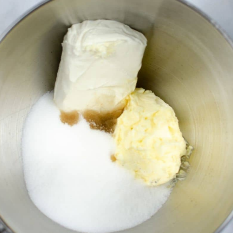 (Cream the Wet Ingredients): Butter, cream cheese, sugar, and vanilla beaten together until light and fluffy in a mixing bowl for a smooth batter base.