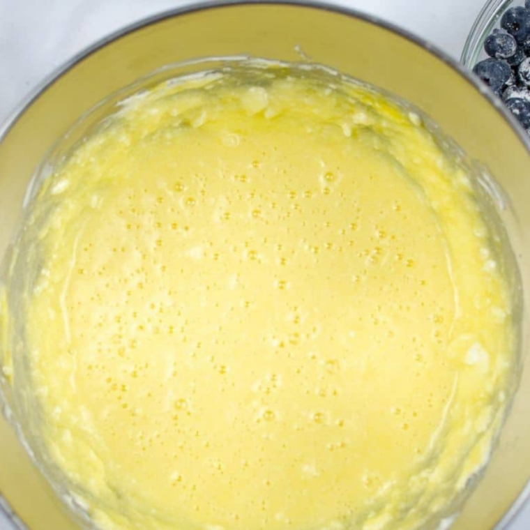 (Add the Eggs): Eggs added one at a time into creamed mixture while mixing until fully incorporated and silky.