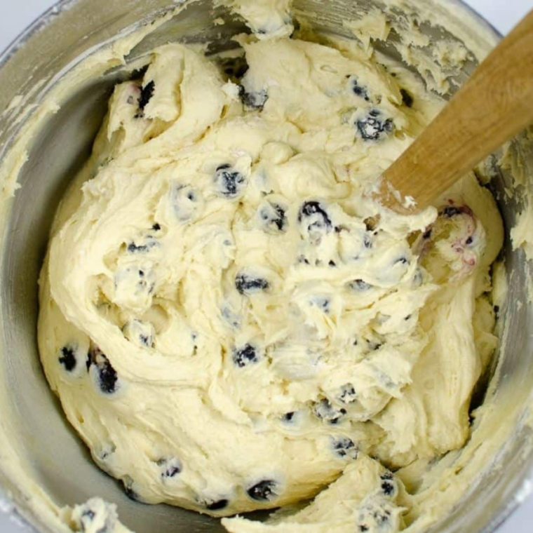 (Fold In the Blueberries): Flour-coated blueberries gently folded into batter with a spatula to avoid crushing and streaking.