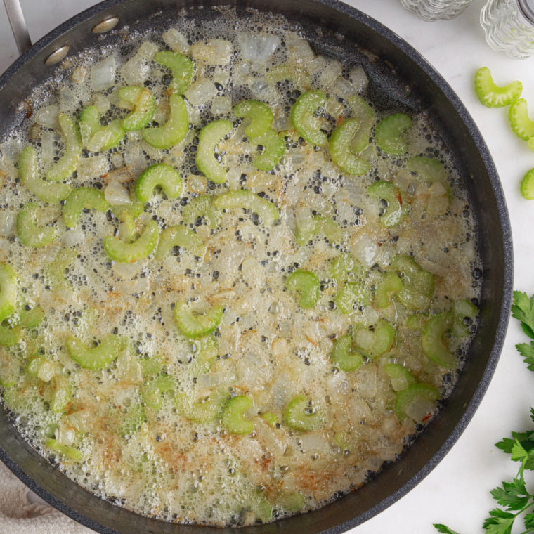 Onion, bell pepper, celery, and garlic cooking in butter with flour for a roux