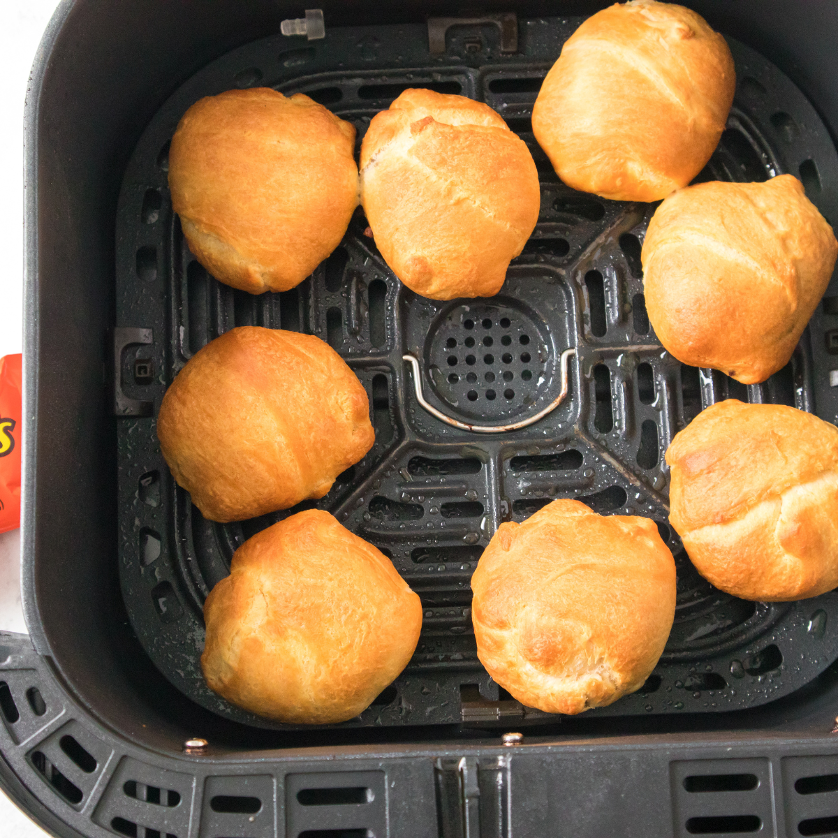 The wrapped bombs are placed seam-side down in a single layer with space between each one. This position helps keep the dough sealed while it puffs and bakes.