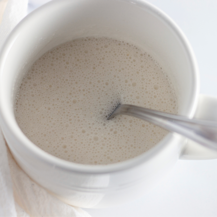 Vanilla mug cake batter poured into a greased mug and filled two thirds full
