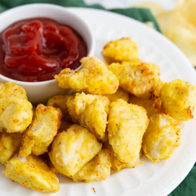 Air fryer Chick-fil-A chicken nuggets served crispy and golden in a bowl with dipping sauce