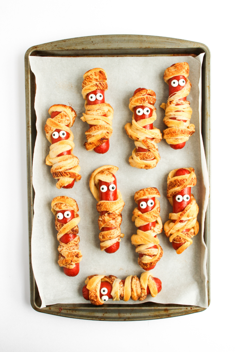 Finished air fryer mummy hot dogs served with dipping sauces.