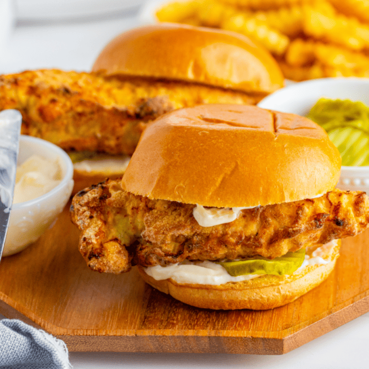Golden air fryer Popeyes-style chicken sandwich on a brioche bun with pickles, crispy coating, and mayo.