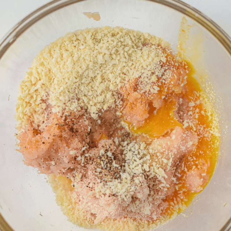 Mix the meatballs
Ground chicken, egg, Parmesan, garlic, and parsley mixed together in a bowl