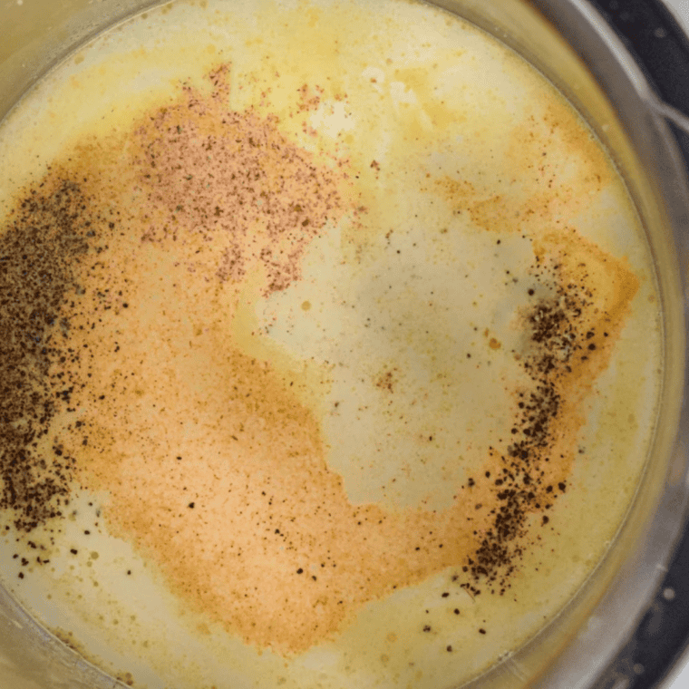 Build the Alfredo sauce
Garlic cooking in melted butter with heavy cream added to a skillet