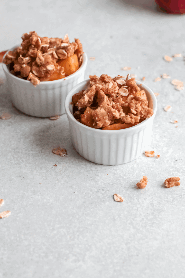 Warm Cracker Barrel Baked Apple Dessert copycat recipe topped with a scoop of melting vanilla ice cream.