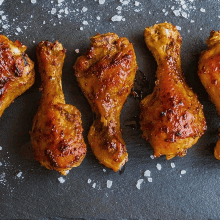 Close up of Easy Instant Pot Honey Chicken Drumsticks on kitchen table.