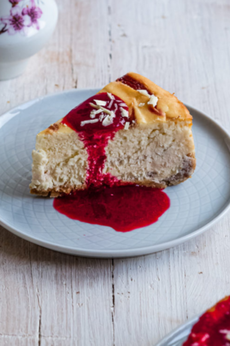 Pressure cooker strawberry cheesecake topped with glossy strawberry sauce and whipped cream