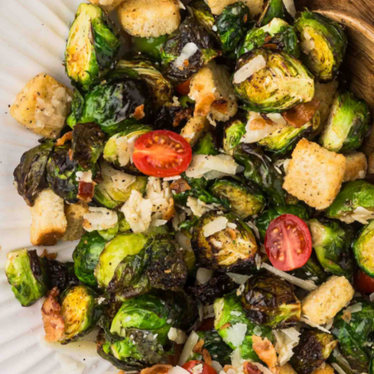 Lazy Dog Brussels sprouts recipe in a cast iron skillet with crispy croutons, capers, and grated Romano