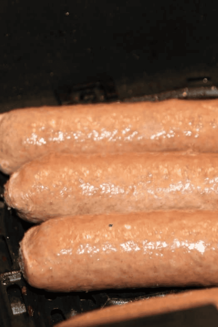 Arranging Beyond Sausage in a single layer in the air fryer basket.