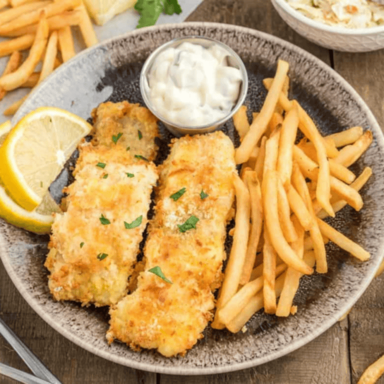 Air fryer breaded salmon served with roasted vegetables and a lemon wedge