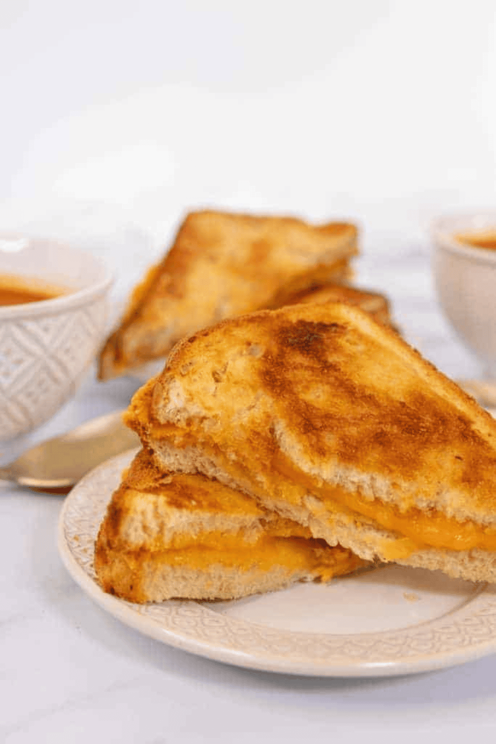 Golden, crispy air fryer grilled cheese sandwich with melted cheese inside.