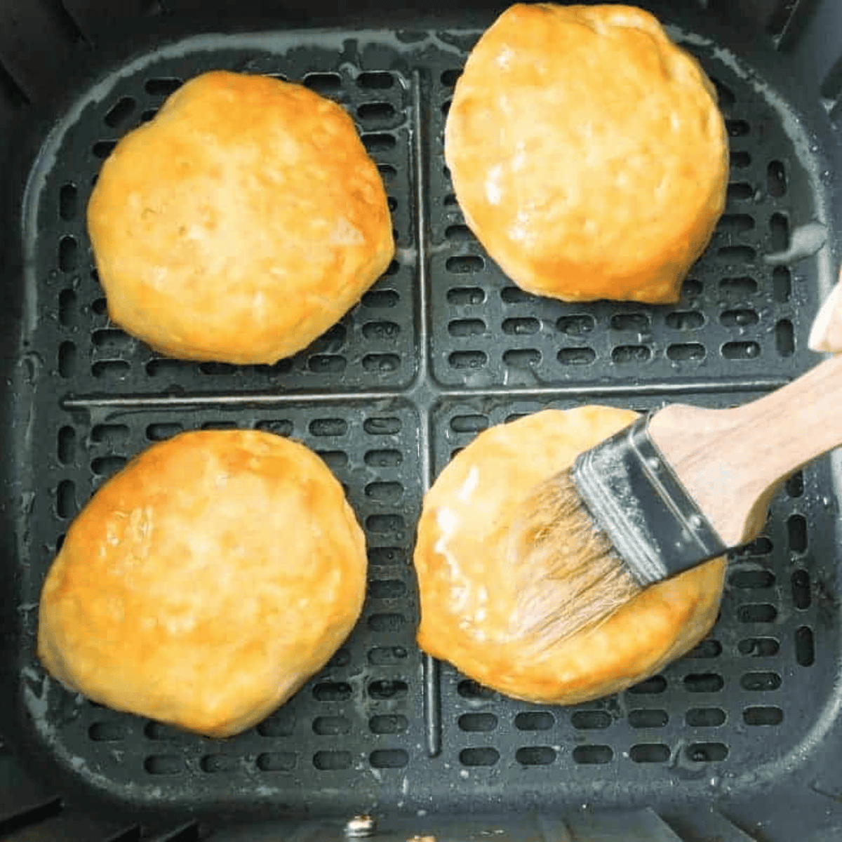 Cinnamon and sugar mixed in a bowl beside melted butter.