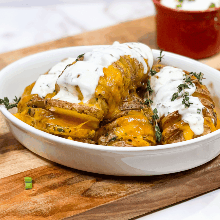 Golden Hasselback potatoes cooked in an air fryer, topped with melted cheese