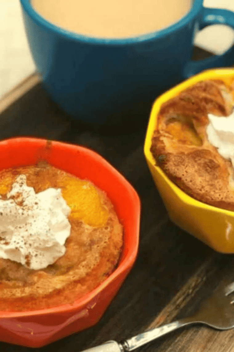 Small ramekin of golden-brown peach cobbler made in the air fryer, topped with whipped cream or ice cream.