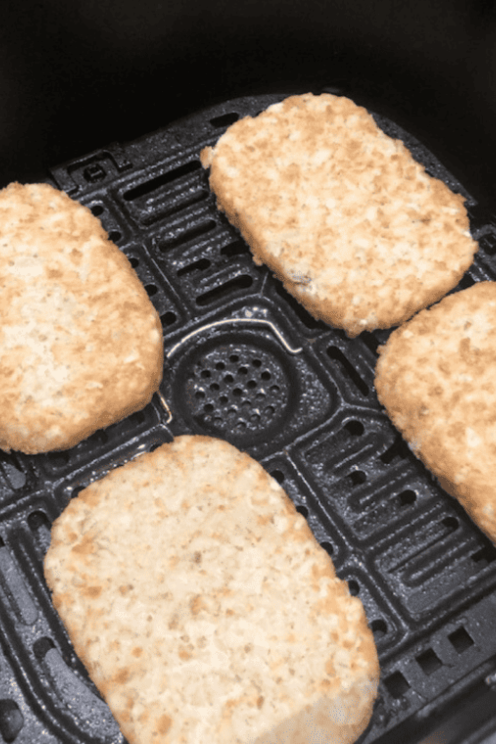 Preheating air fryer to 400&deg;F before cooking frozen hash brown patties to ensure immediate crisping and golden texture instead of steaming