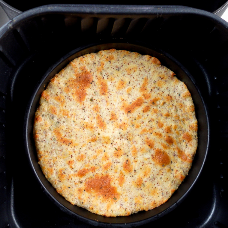 Par-baked 2 ingredient pizza crust, puffed and set, ready for sauce