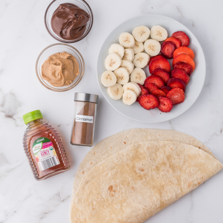 Ingredients for air fryer banana Nutella quesadillas: flour tortillas, Nutella, bananas, butter, cinnamon, and sugar
