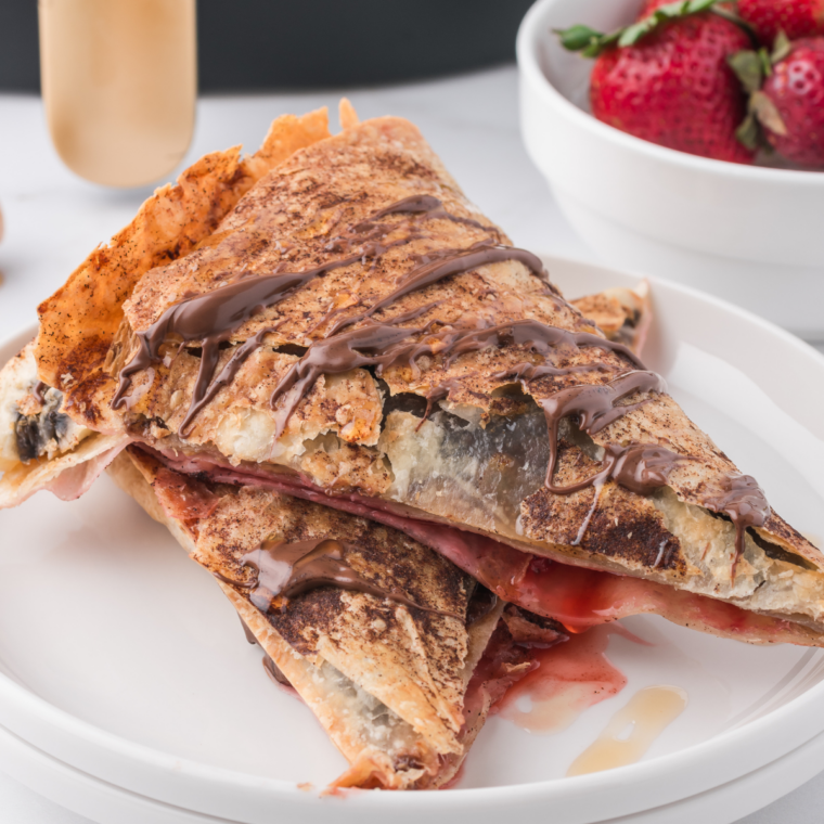 Platter of banana Nutella quesadilla wedges with melted Nutella visible at the cut edges
