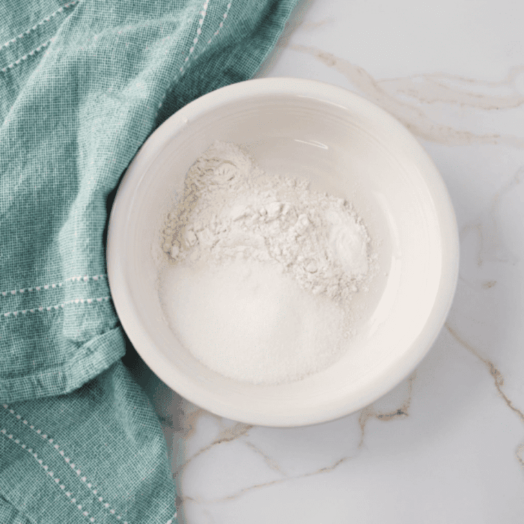 Mixing flour, sugar, and baking powder in a medium bowl