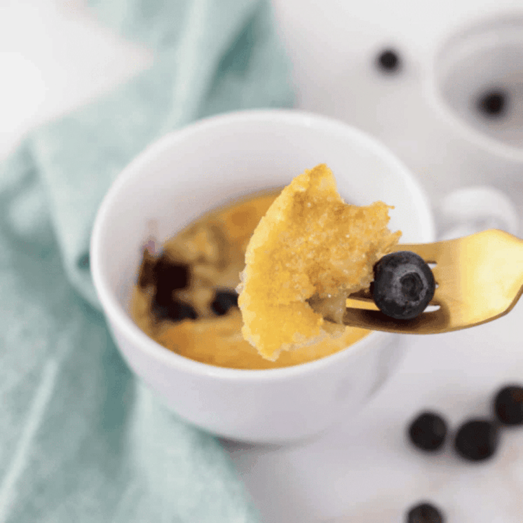Air Fryer Blueberry Muffin Mug Cake with fresh blueberries in a ramekin