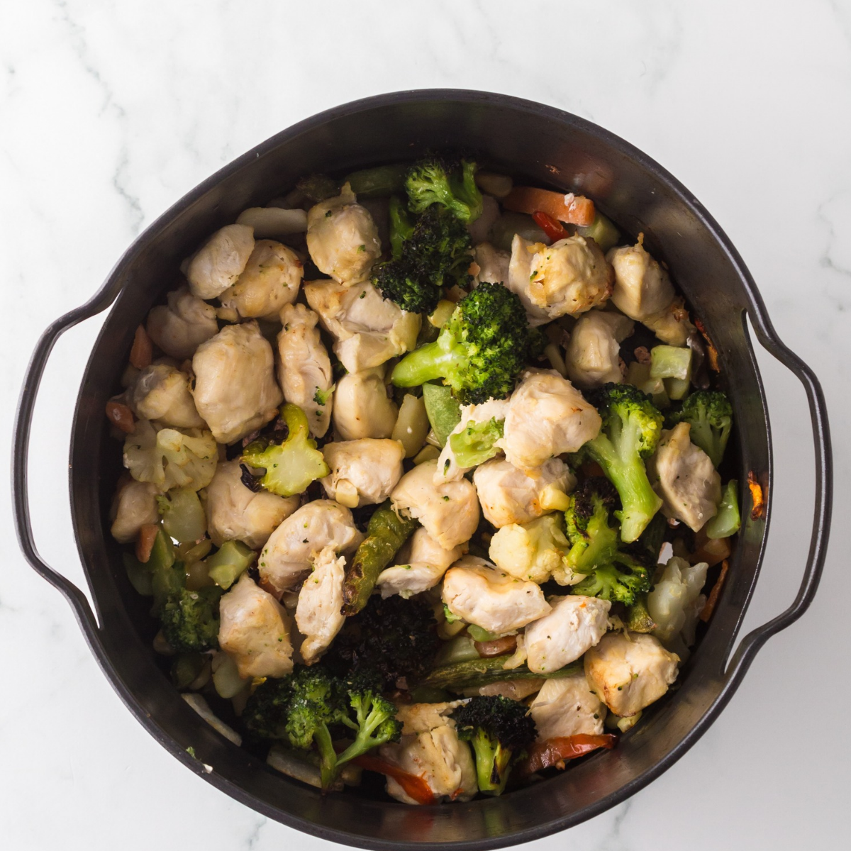 Teriyaki-marinated chicken bites in a single layer in the air fryer basket