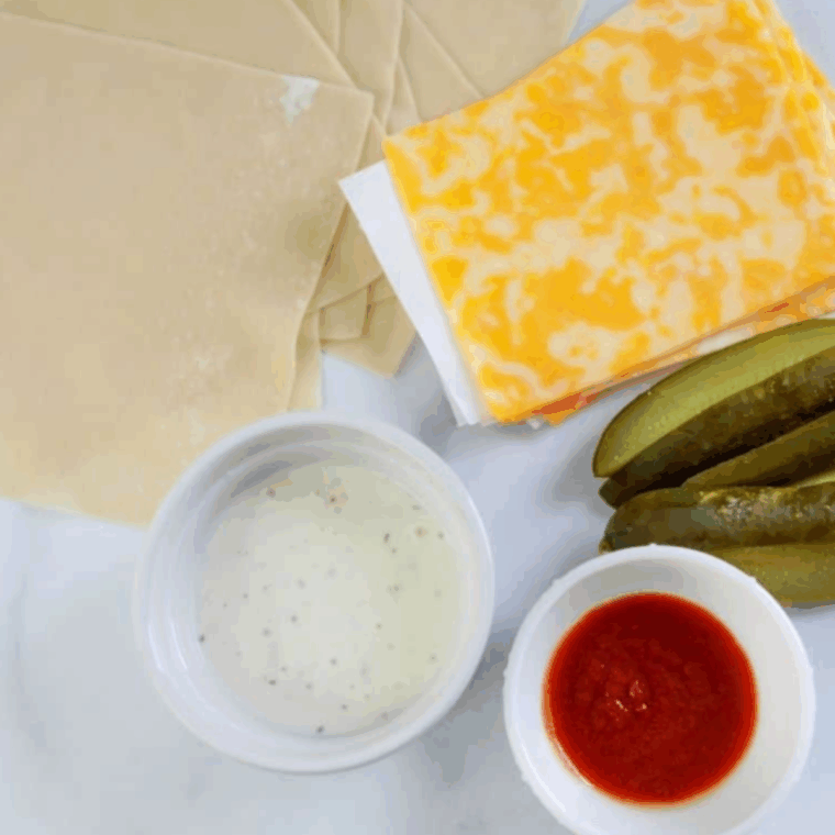 Ingredients needed for Easy Air Fryer Pickle Egg Rolls on kitchen table.