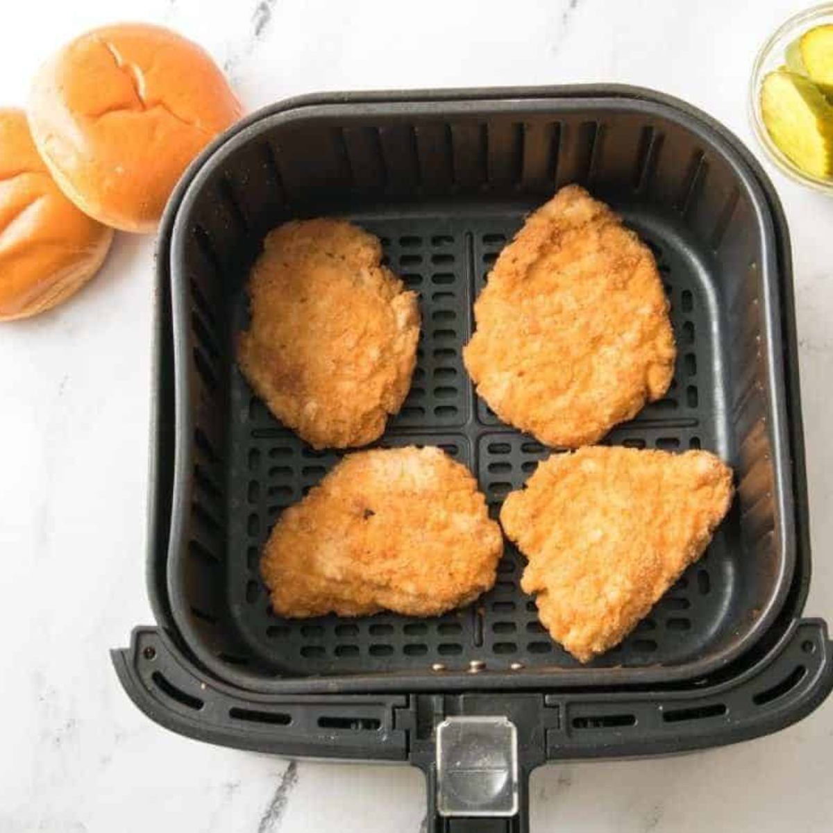 Frozen Aldi Red Bag Chicken fillets arranged in a single layer in the air fryer basket, not touching