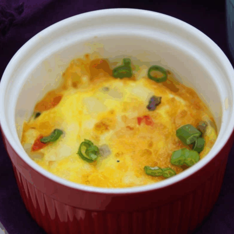 Air Fryer Veggie Egg Bites, golden and fluffy with diced bell peppers, onions, and melted cheese.