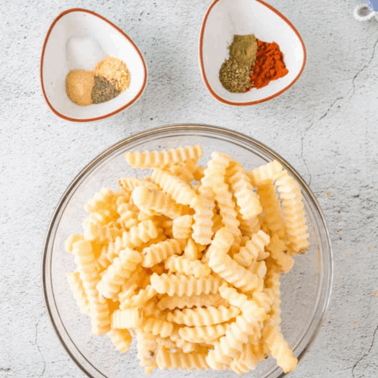 Ingredients needed for Bojangles French Fry Seasoning Recipe on kitchen table.