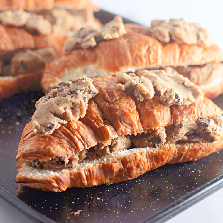 Cookie dough pieces pressed onto the top of a croissant before baking