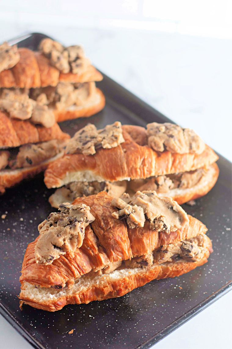 Chocolate chip cookie croissants baked golden brown on a large baking sheet