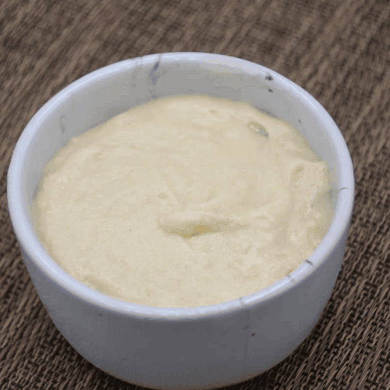 Layer of mug cake batter added on top of apples, ready in air fryer