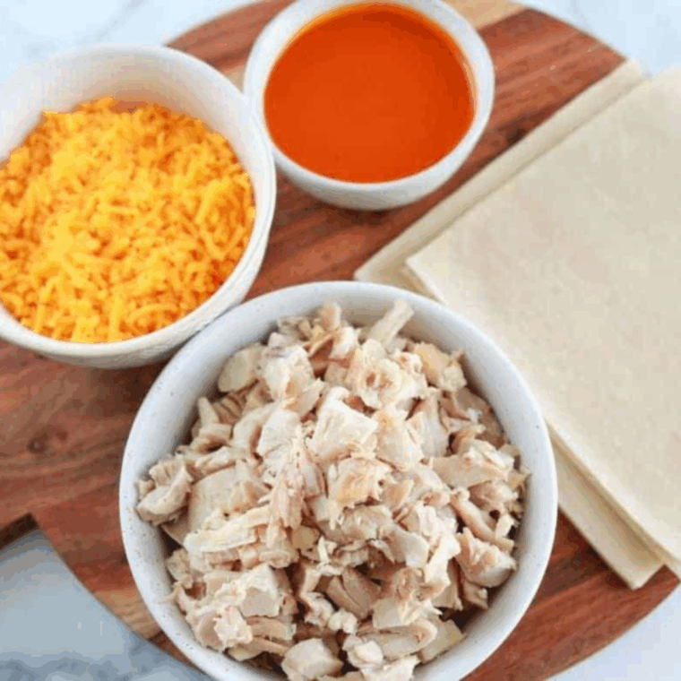 Ingredients needed for Easy Air Fryer Buffalo Chicken Egg Rolls on kitchen table.
